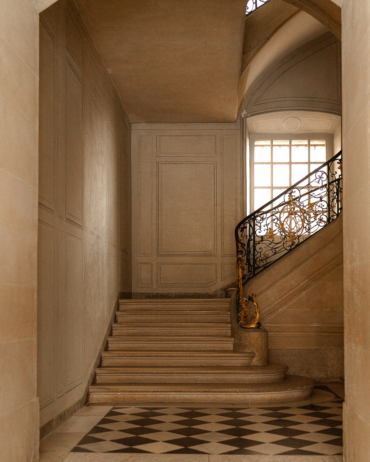 An architecturally unique staircase inside an opulent London building, featuring intricate details.